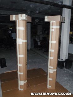 two cardboard pillars in the middle of a room