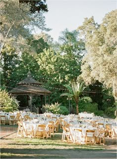 an outdoor wedding venue set up with tables and chairs