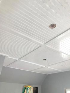 the ceiling in this room is white and has no curtains on it, as well as a light fixture