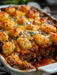 a casserole dish with meat and cheese on top, sitting on a table