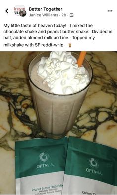 two bags of ice cream sitting on top of a counter next to a cup filled with whipped cream