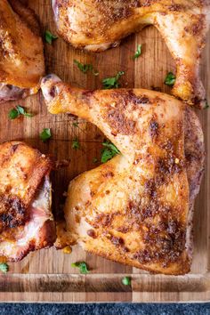 two chicken legs on a cutting board with parsley