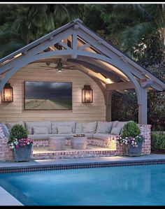 an outdoor living area next to a swimming pool