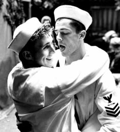 black and white photo of two sailors hugging each other