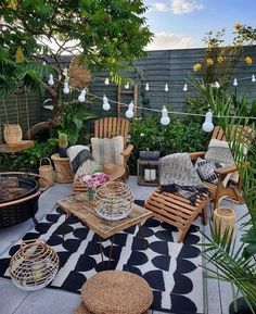 an outdoor living area with chairs and tables