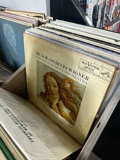 an old record player's album is sitting on top of some records in a box