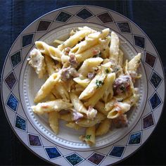 a white plate topped with pasta and meat