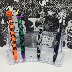 three halloween themed pens in a clear holder