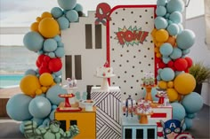 a table topped with balloons and cake