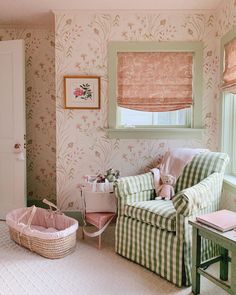 a living room filled with furniture and wallpaper next to a baby's crib