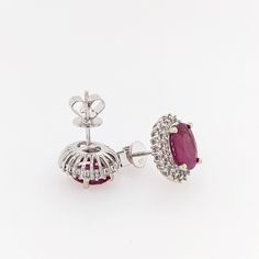 Add a pop of fiery color to any outfit with these sunburst red ruby studs. Crafted with 14k white gold, these earrings are perfect for July birthdays and will add a dainty sparkle to your look. The oval 9x7mm rubies are surrounded by a natural diamond halo. Make a fun and bold statement with these unique studs! Unique Studs, July Birthday, Red Ruby, Diamond Halo, Bezel Setting, Halo Diamond, Rhodium Plated, Prong Setting, Natural Diamonds