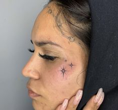 a woman with a star tattoo on her forehead