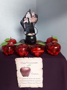 a table topped with red glass apples and a sign that says my apple envenient