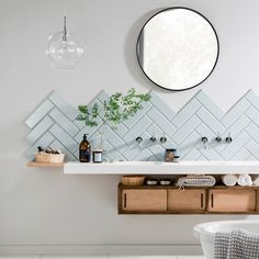 a bathroom with a sink, mirror and bathtub in it's center area