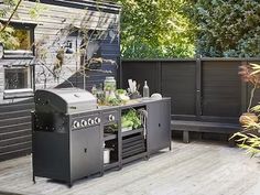 an outdoor bbq grill on a wooden deck