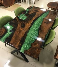 a wooden table with green chairs around it