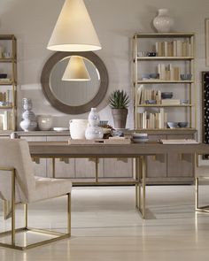 a dining room table with two chairs and a lamp