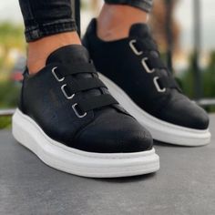 Step into the world of "Luiz Monochrome Mastery." These slip-on sneakers elegantly pair a deep black vegan leather with contrasting white soles, designed for those with a penchant for classic contrasts and unparalleled comfort. Key Features: Black & White Fusion: A timeless pairing that never goes out of style. Slip-On Design: For instant sophistication without the fuss. Vegan Leather: Ethical elegance, seamlessly achieved. Orthopedic Insoles: Ensuring comfort with every move. 1.5-Inch Height Bo Shoes For Men Stylish, New Trend Shoes, Black And White Sneakers, Lightweight Sneakers, Black Shoes Women, Women Men Shoes, Custom Sneakers, Sneakers Men Fashion, Classic Sneakers