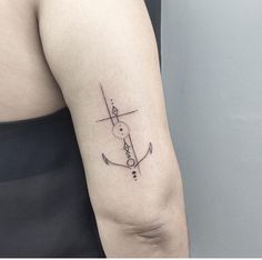 a woman's arm with an anchor tattoo on the left side of her arm