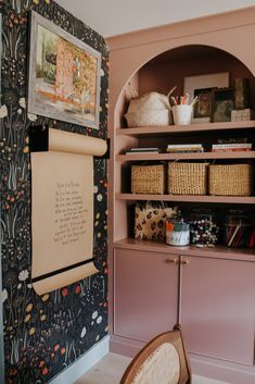 a room that has some bookshelves and baskets on the shelves next to it