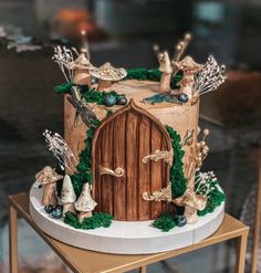 a cake decorated with animals and trees on top of a table