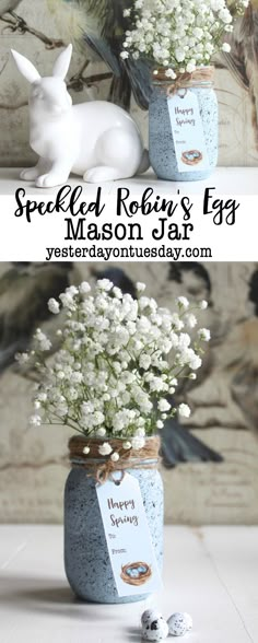 a vase filled with baby's breath flowers next to a bunny figurine