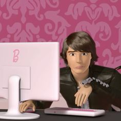 a cartoon character sitting in front of a computer monitor with the letter b on it