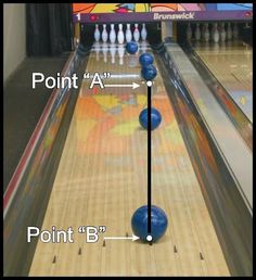 the bowling ball is about to be hit by the pins on the bowling alley lane