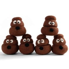 a pile of brown teddy bears with googly eyes on their faces and noses, sitting next to each other in front of a white background