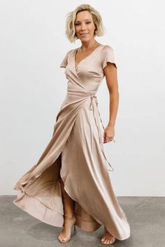 a woman in a tan dress posing for the camera