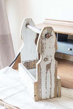 an old pair of white wooden chairs sitting on top of a rug next to a dresser