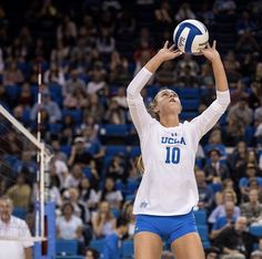 a female volleyball player getting ready to serve the ball