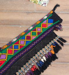 "almost 32.00 cm x 132.00 cm = 12.60\" x 51.97\" black blue red white orange green purple 1940s - 50s from Uzbekistan handmade tassel - segusha dry clean only VINTAGE UZBEK TASSELS : \" Segusha \" ( Triangle ) is a decorative embellishments, whose function, was to decorate the beddings tucked away folded against the walls of a yurt or tent. These objects made with great care were attached on the corner of squarish textiles and used as covers . The silk tassels with beads and metal work are charm Bohemian Festive Dupatta With Tassels, Bohemian Festival Dupatta With Tassels, Traditional Festival Dupatta With Tassels, Bohemian Dupatta With Tassels For Festivals, Bohemian Dupatta For Beach Festivals, Bohemian Dupatta With Multicolor Embroidery, Bohemian Embroidered Dupatta, Bohemian Black Dupatta With Woven Motifs, Festive Multicolor Tasseled Dupatta