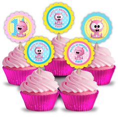 cupcakes with pink frosting and colorful decorations