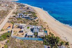 an aerial view of a beachfront home in the middle of the ocean with blue water