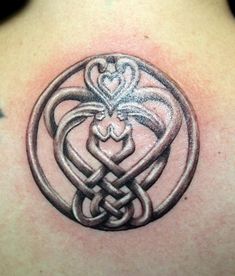 a tattoo design on the back of a woman's shoulder, with an intertwined knot