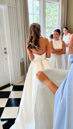 the bridesmaids are getting ready for their big day at the wedding ceremony in white dresses