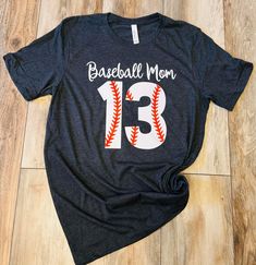 Baseball Mom number T-Shirt Baseball Season Graphic Print Crew Neck T-shirt, Tri-blend T-shirt With Graphic Print For Baseball Season, Short Sleeve Graphic Tee With Number Print, Graphic Tee With Number Print And Short Sleeves, Casual Sports T-shirt With Number Print, Sports Season Fan Apparel Tops With Number Print, Pre-shrunk Graphic Tee For Sports Season, Black Sports T-shirt With Number Print, Black T-shirt With Baseball Screen Print