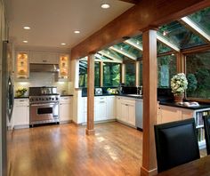 an open kitchen and dining room with wood flooring