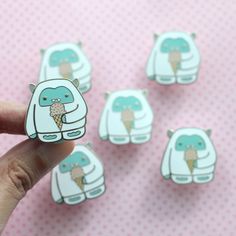 a person is holding some ice cream stickers