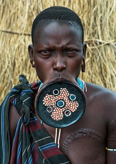 an african man holding a mirror in front of his face