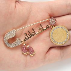 This iced out Islam baby pin brooch is the perfect accessory for your little one's special occasion. This exquisite pin brooch is delicately crafted with premium materials to ensure a lasting and stunning shine. The pin features a beautifully designed Islamic symbol, making it an ideal addition to any traditional or modern Islamic outfit. It's a great way to add some sparkle and elegance to your baby's look while also expressing your religious beliefs. SPECIFICATIONS Material: Metal Brooches Typ Muslim Quran, Hip Hop Bling, Pin Man, Hip Hop Outfits, Blue Evil Eye, Crystal Brooch, Buying Jewelry, Pin Brooch, Purple Gold