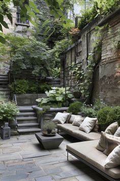 an outdoor living area with couches and plants