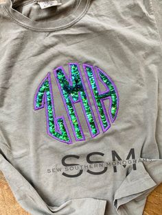 How fun are our mermaid sequin tees! These are PERFECT for Spring and Summer time or wear them year round! Contact me if you have any questions in regards to ordering Please include with your order: 1-Initials(First, LAST, middle) Ex: Julie M Tate- (jTm) 2-Thread Color 3-Shirt Color 4-Phone number- in case we have any questions regarding your order ---Returns/Refunds--- Please note that refunds of customized hand decorated items are not available. All sales are final. If for some reason you are Southern Monogram, Casual Outfits For Moms, Sequin Tee, Mermaid Sequin, Sequin Appliques, Summer Tee, Mom Outfits, Hand Decorated, Shirt Color