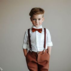 a young boy wearing suspenders and a bow tie