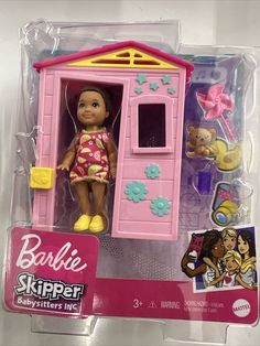 the doll is in its pink plastic box