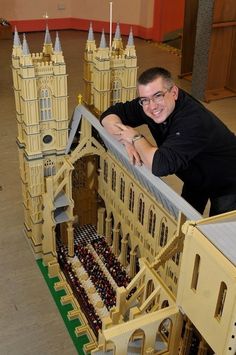 a man standing next to a model of a building