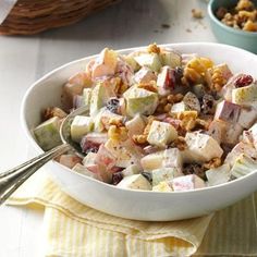 a white bowl filled with fruit and nuts