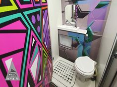 a colorful bathroom with a toilet and sink