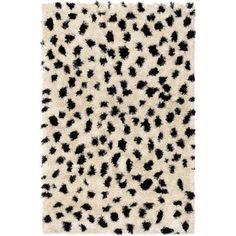 an animal print rug with black and white spots on the top, in front of a white background